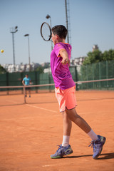 Young tennis player playing backhand