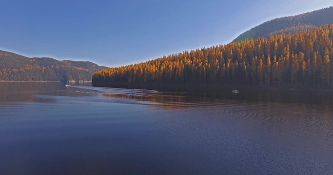 Aerial Drone Shot in Montana on a lake with a boat in the Fall or Autumn