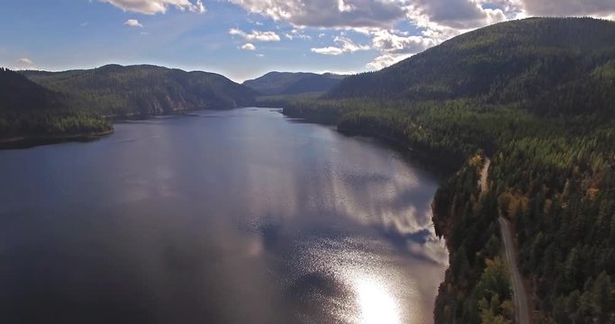 Aerial Drone Shot in Montana on a lake with a boat in the Fall or Autumn