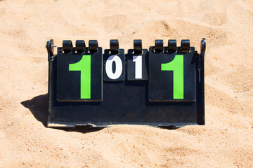 Close up of sport volleyball scoreboard on the summer sand. Score - tie, 1-1
