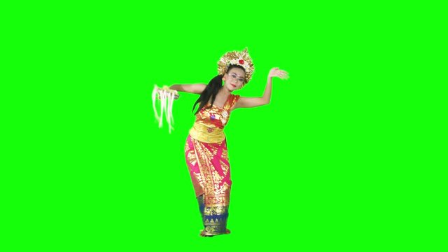 Female traditional balinese dancer dancing in the studio with traditional costume. Shot in 4k resolution with green screen background