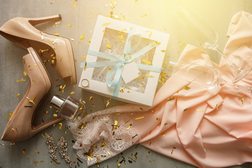 Gifts for merry christmas: silk pajama, shoes, engagement ring, shoes, gift box, perfume, jewelry, glasses, confetti. Christmas concept