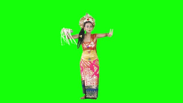 Beautiful female traditional pendet dancer dancing in the studio with traditional costume. Shot in 4k resolution with green screen background