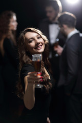 Plakat happy young woman raising glass in toast