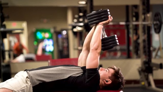 Closeup side shot of bodybuilder doing lying triceps pullover or presses.
