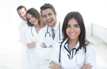Fototapeta premium female doctor with group of happy successful colleagues