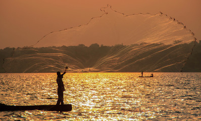Fisherman throws a net in Lake Victoria. Uganda