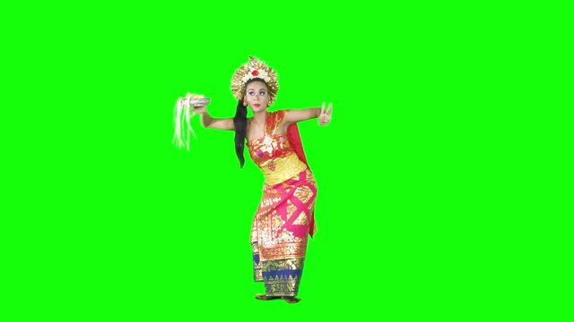 Indonesian woman perform a Balinese dancing over green screen