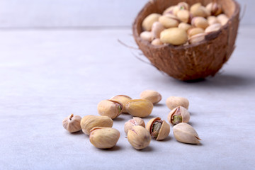 handmade bowl of coconut with pistachios isolated on a white background. Close-up.