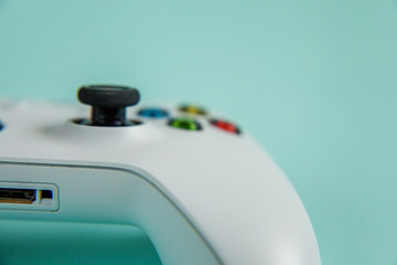 White joystick gamepad, game console on blue colourful trendy modern fashion pin-up background. Computer gaming competition videogame control confrontation concept. Cyberspace symbol