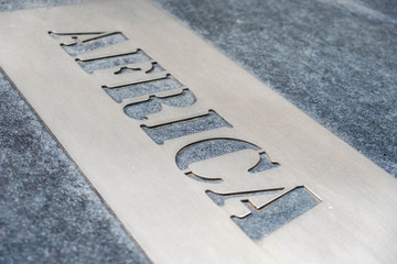 Fototapeta premium Metal label un marble with name of the continent Africa. Close up detail.