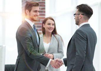 handshake business partners at a meeting