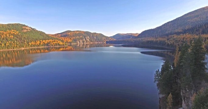 Aerial shot of a Drone flying in and out of shot on a Lake in Montana in the Fall or Autumn