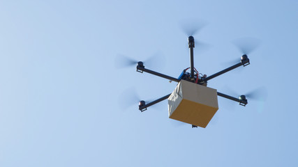 CLOSE UP: Futuristic package shipment by helicopter drone. Air cargo delivery
