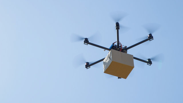 CLOSE UP: Futuristic Package Shipment By Helicopter Drone. Air Cargo Delivery