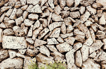 Texture of a stone wall. Old castle stone wall texture background. Stone wall as a background or texture. Part of a stone wall, for background or texture. A typical wall of Menorca island.
