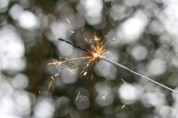 New Year's party sparkler with beautiful bokeh background. 