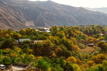 View of the yellowed autumn gardens, of a small village located high in the mountains Geghama ridge located in Armenia
