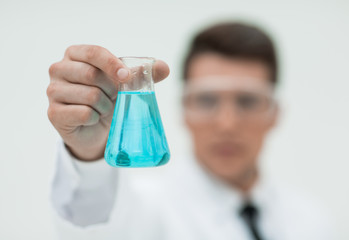 background image of a test tube in the hands of a modern scienti