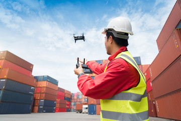 Foreman control drone to fly to survey the area worth in container yard