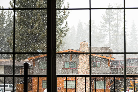 Looking outside through a window at falling snow, South Lake Tahoe, California