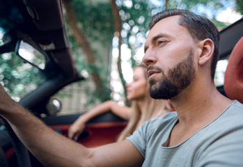 close up.a handsome man driving a luxury car