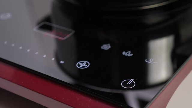 Choose function on Induction stove and set power of heating