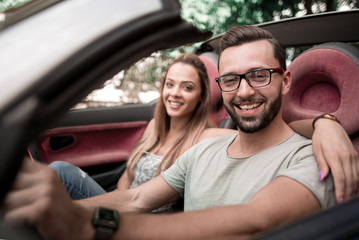 close up.stylish man with his girlfriend traveling in a converti