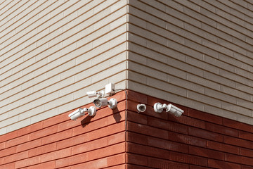 CCTV cameras on the wall. Monitor the security of a multi-story building or a private house. Security Agency