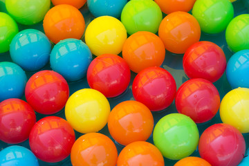 Colour toy balls in a pool