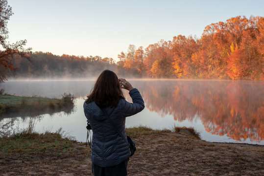 Taking pictures of an autumn pond