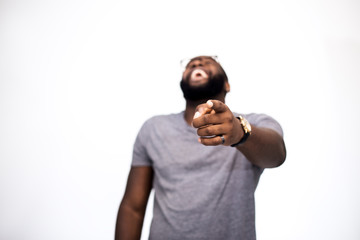 Sneer, a finger, mocks someone and laughing man. Hand in focus. In the blur of an African American...