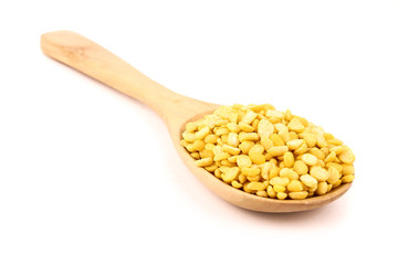 peeled split mung bean in wooden spoon isolated on white background.Ingredients for cooking Healthy and Natural Food concept