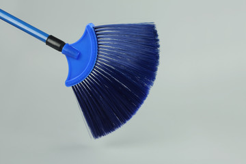 Plastic broom stick isolated on gray background