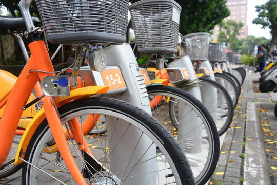 city bike, a row of public bicycles for rent parking on footpath in Taipei. Taiwan