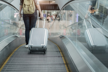 Close up lower body of woman traveler with luggage suitcase going to around the world by plane....