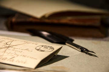 Old letter, feather and a book. Vintage background