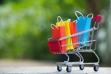 Colorful paper shopping bags in a trolley,E-commerce concept.