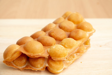 Fototapeta na wymiar Dessert Hong Kong egg Waffle or bubble waffle on wood background.