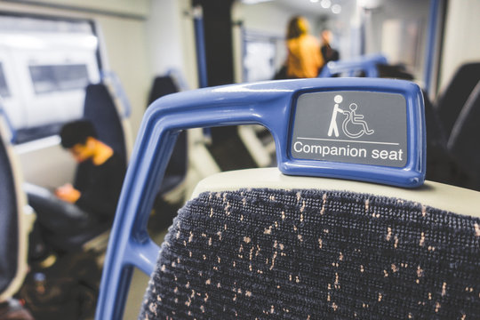 Close up of handle or handheld seat for disability people in train, tube and underground in Europe. Priority seat for disability people concept.