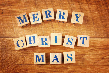 Wooden cubes with Merry Christmas festive text on wooden background