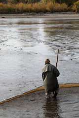 One fisherman holds a net in the water
