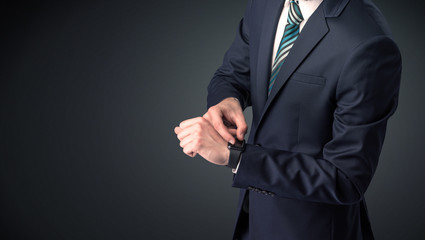 Obraz na płótnie Canvas Man wearing suit with smartwatch on his wrist.