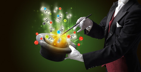 Illusionist conjure with magic wand gambling things from a cylinder