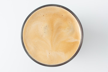 Coffee with frothy foam  top view closeup isolated on white background.