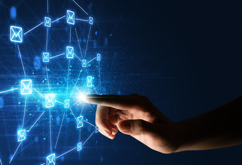 Female finger touching a beam of light surrounded by a blue graphic with envelopes