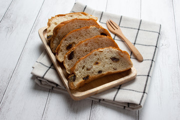 slices raisin bread on wooden board