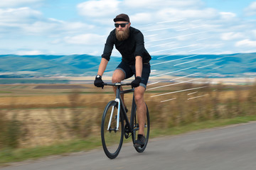 Fototapeta na wymiar Casual hipster cyclist riding bicycle with high speed concept