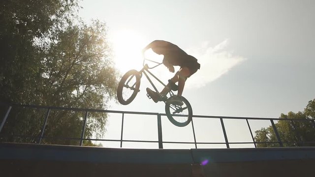Table top in skatepark, bmx bike trick on pipe