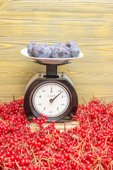 Сливы взвешены на механических весах.